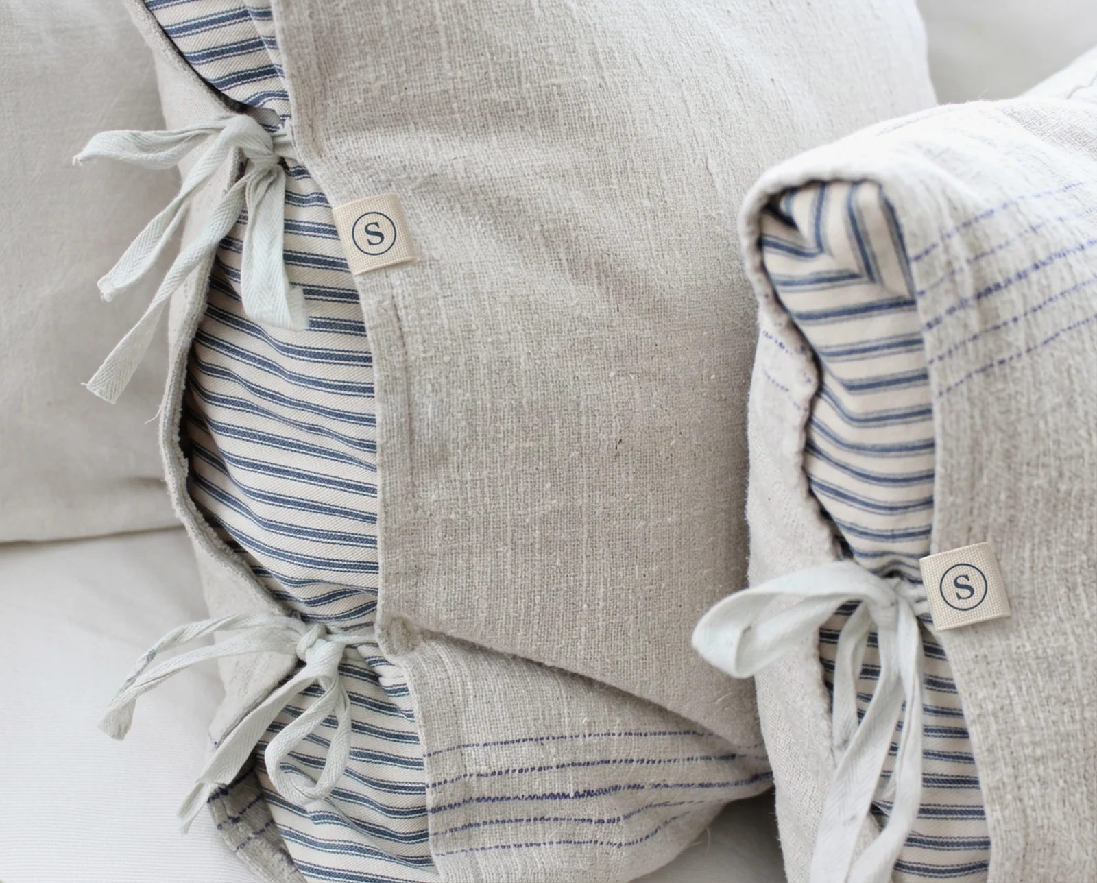 Linen bedding with ticking-stripe lining, tie closures and the woven S tab